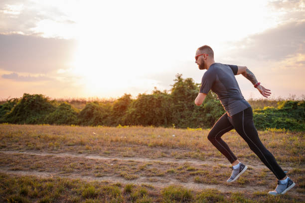 istock Differently abled young man running in nature at dusk 1302598265