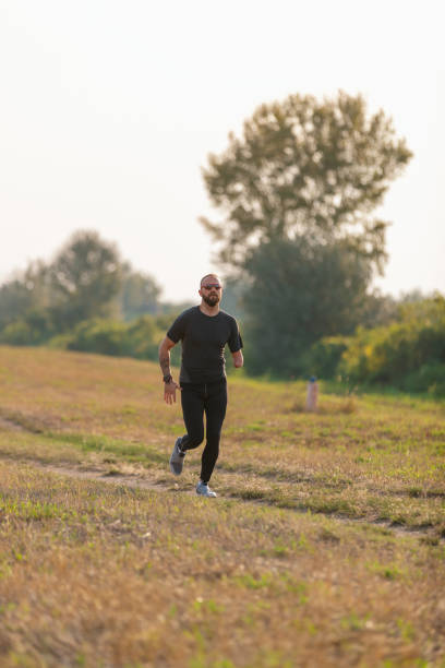 istock Differently abled young man jogging in nature 1302598287
