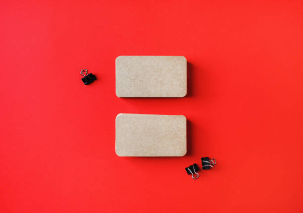 istock Kraft business cards on red 1302598925