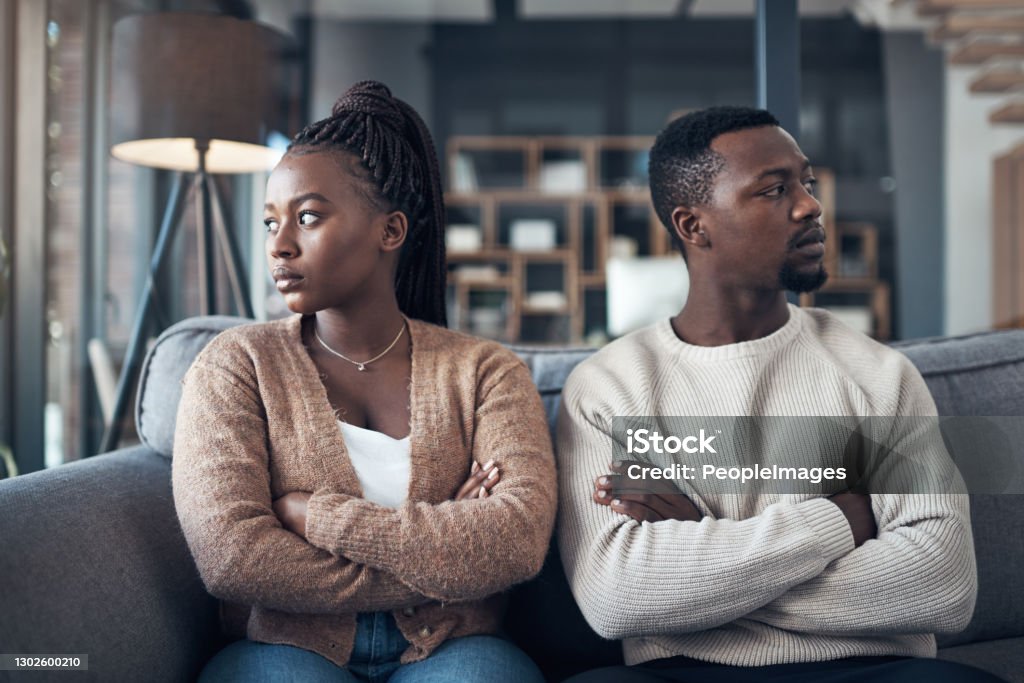We can't even communicate Cropped shot of a young couple sitting on the sofa and giving each other the silent treatment after an argument Couple - Relationship Stock Photo