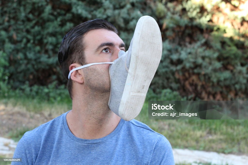 Comedian with shoe covering mouth Comedian with shoe covering mouth. Meme Stock Photo
