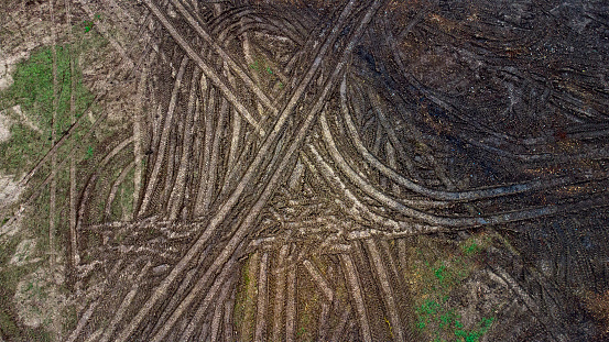 Tire tracks on muddy underground - construction site, aerial view