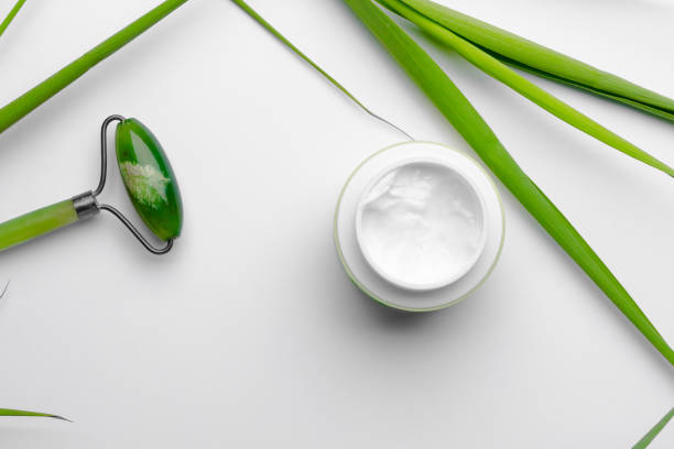 istock Face care moisturizer on white background with chinese face massage kit 1302602069