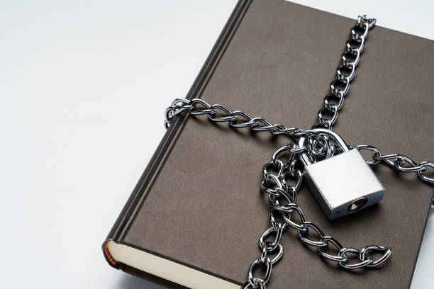 Hardback book and padlock on white background Hardback book and padlock on white background diary lock book cover book stock pictures, royalty-free photos & images
