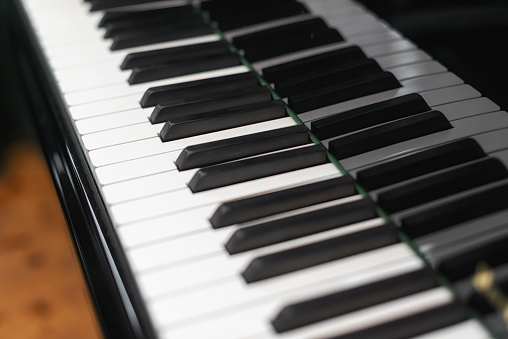 close up of a piano keyboard of a concert grand piano in a music room
