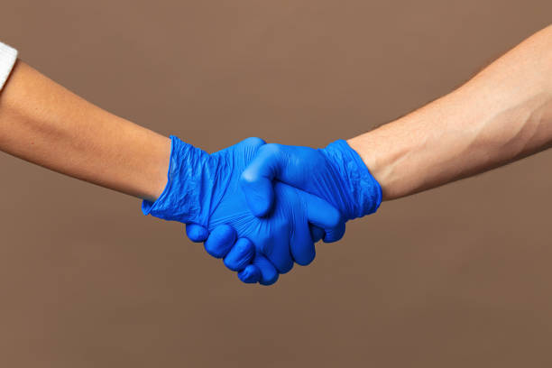 istock Handshake in a blue gloves, help concept. Personal hygiene during a pandemic 1302605682