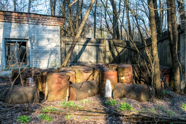 istock Old rusty barrels with toxic waste. Environmental pollution 1302605990