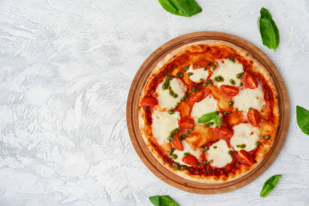 istock Top view of pizza Margherita on gray surface 1302608001