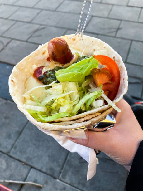 istock Flatbread wrap with instant mash potatoes, grilled hot dog and salad. 1302608587