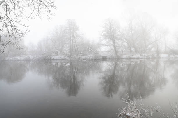 Misty reflections in the Teviot river in the Scottish Borders, UK
