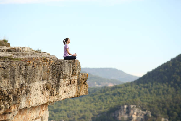 istock Yogi practicing yoga exercise in the top of a mountain 1302611213