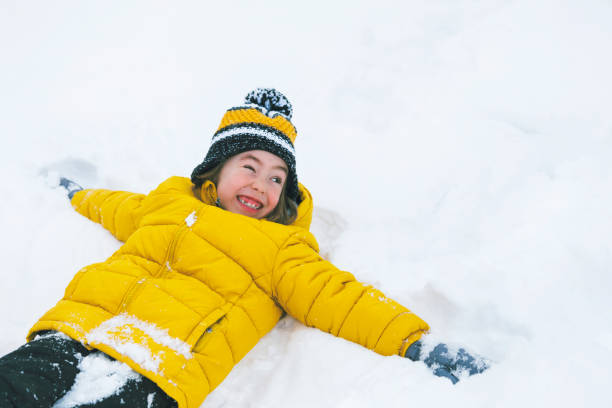 istock Happy child playing in the snow 1302611573