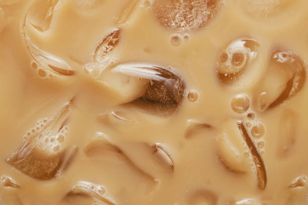 Close-up of Cold latte drink with ice cubes, Close-up of Cold latte drink with ice cubes, iced coffee texture. texture cafe stock pictures, royalty-free photos & images