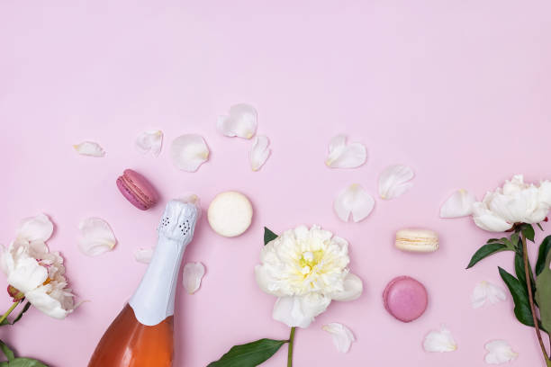 istock Spring composition with rose sparkling wine, white peonies and macarons 1302612725