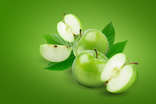 Fresh green apples isolated on green background