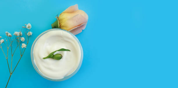 istock cream cosmetic rose flower on colored background 1302613372