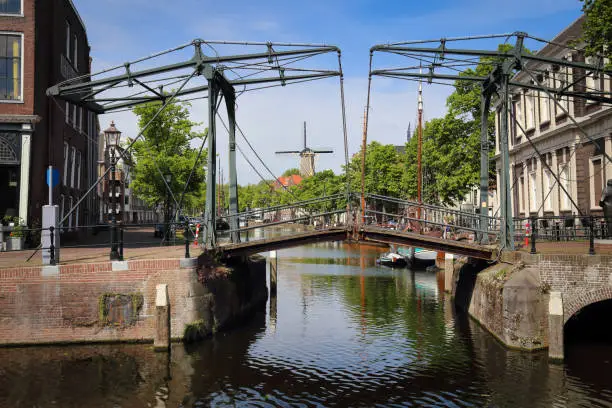 Historical drawbridge across a canal and a windmill in Schiedam, Holland