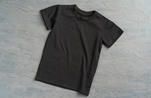 Black color plain t-shirt with copy space Black color plain t-shirt with copy space close up tee stock pictures, royalty-free photos & images