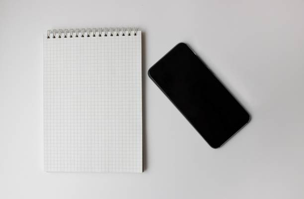 istock notebook and smartphone lie on a gray background 1302614119