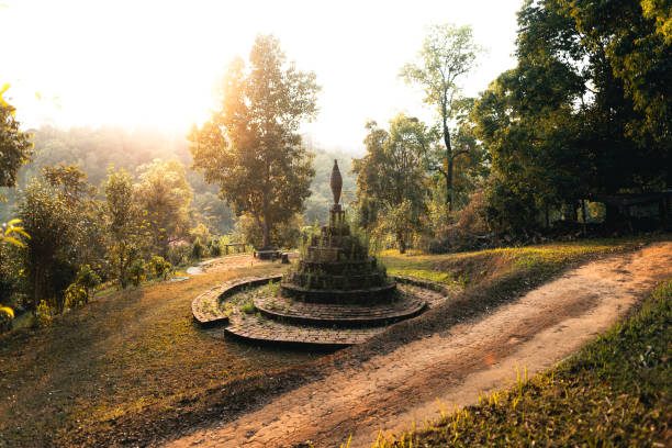 A large stone Buddha statue carved on a mountain in Thailand.