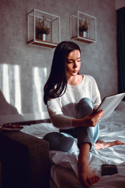 istock Fun Times With Technology in Bed For Modern Asian Female 1302616410