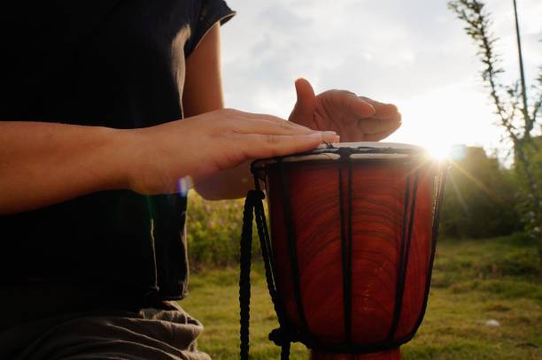 istock Woman`s hands playing a drum in the park 1302617202