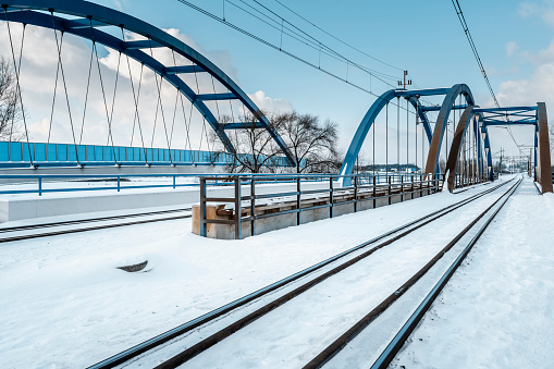Entrance to the railway bridge, tracks covered with snow. South-west Poland.