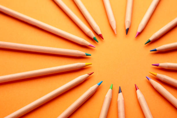 istock Colored pencils on the orange background. Top view. 1302618487