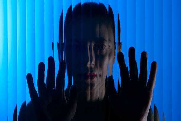 Woman behind corrugated glass. Concept of psychological problems
