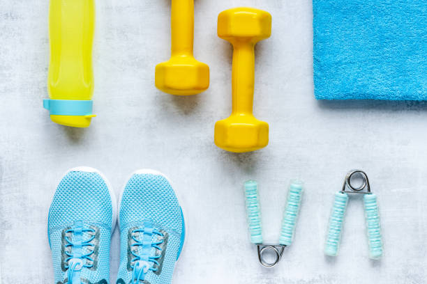istock Athlete equipment with dumbbells and sneakers. Overhead view 1302622254