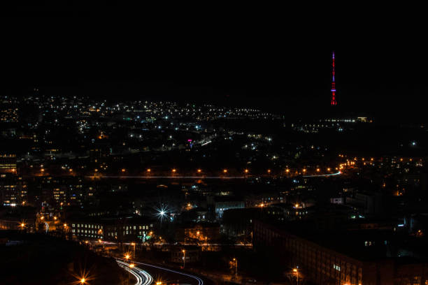 istock Light paths on the highway in the night city 1302622663