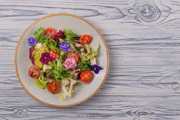 istock Beautiful healthy spring salad decorated with flowers 1302623966