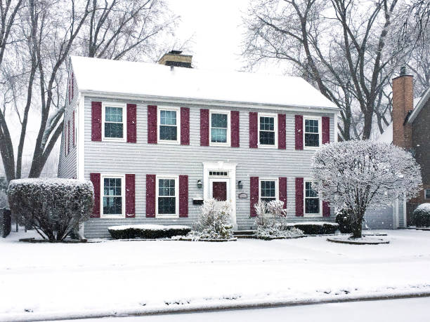 Saltbox Colonial House in Snowstorm