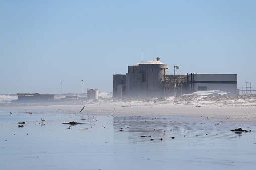 Cape Town, South Africa - 16 February 2021: A general view of the Koeberg Nuclear Power Station near Melkbos on February 16, 2021 in Cape Town, South Africa. It is reported that both Eskom and the National Nuclear Regulator (NNR) have dismissed safety claims raised by activists that sea air corrosion at the Koeberg containment building endangers the public.