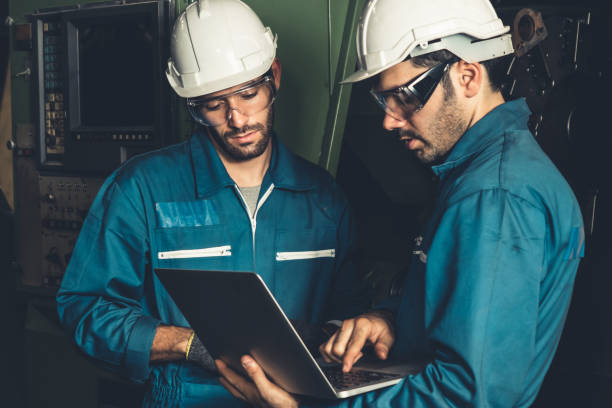 istock Group of skillful factory workers using machine equipment in workshop 1302626209