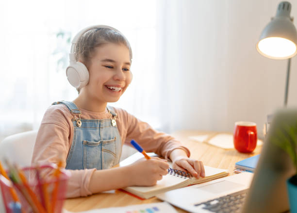 istock Girl doing homework or online education. 1302627072