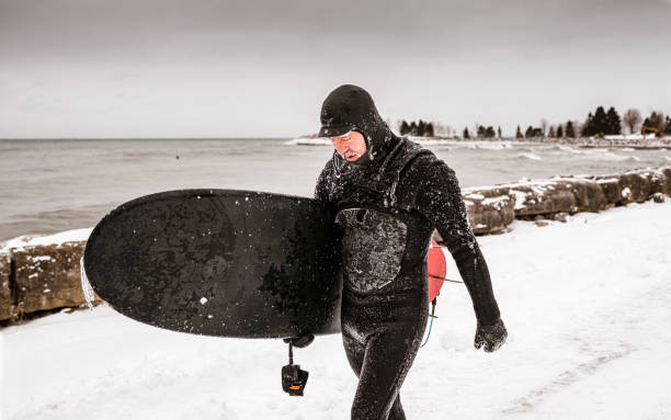 istock Mature man after surfing session in the winter 1302633286