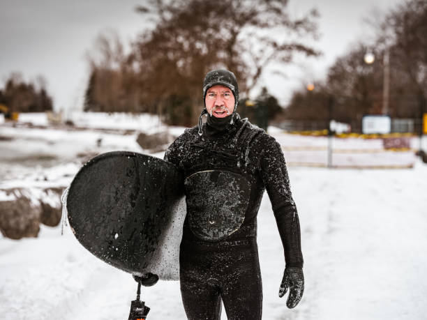istock Mature man after surfing session in the winter 1302633938