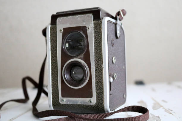istock Old Dusty Beat-Up Vintage Film Camera on Table 1302633994