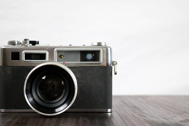 istock Dusty Old Vintage 35mm Film Camera on Table with Copy Space 1302634159