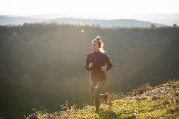 istock Young female athlete running in the mountain. 1302634307