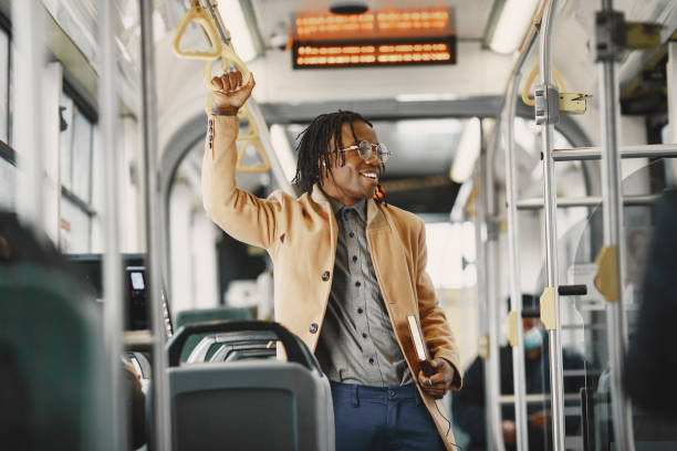 istock Young African businessman standing on a bus 1302635956