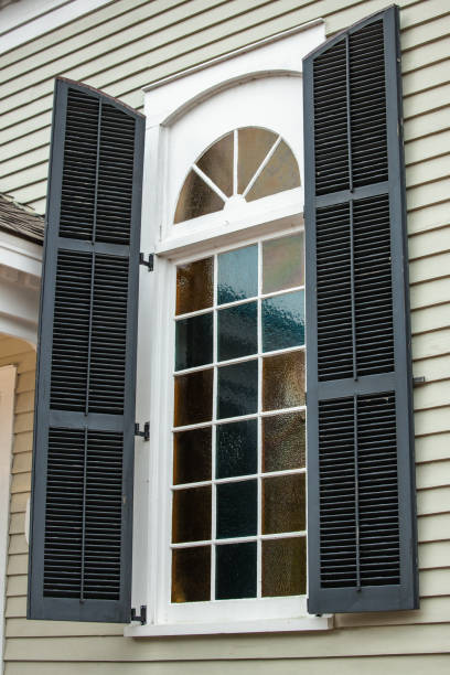 istock Large exterior view of a window with a curved semi circle top portion 1302636052