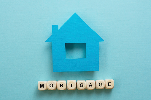 Mortgage word concept blue background, top view