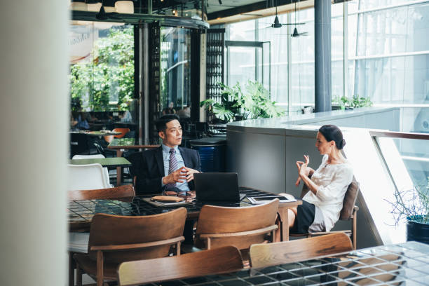 istock Business colleagues discussing work at office cafeteria 1302637749