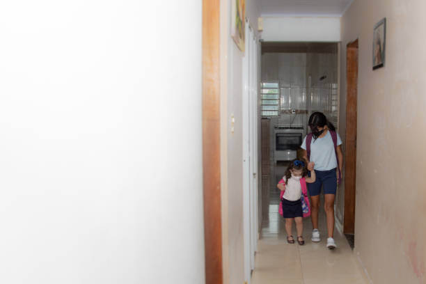 istock sisters leaving home for school wearing mask 1302641450