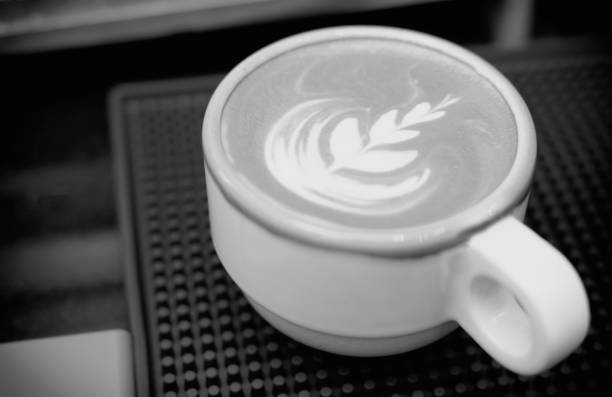 istock Hot latte coffee with latte art in white ceramic cup. Black and white tone 1302641630