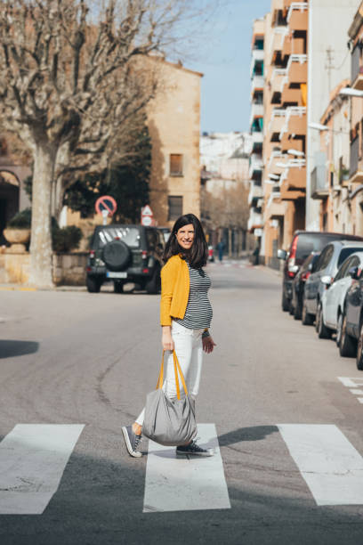 istock Pregnant woman walking on the streets going work. 1302642269