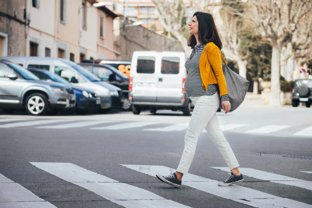 istock Pregnant woman walking on the streets going work. 1302642295