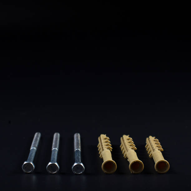 istock Hardware isolated on black. Dowels on black with copy space 1302643006